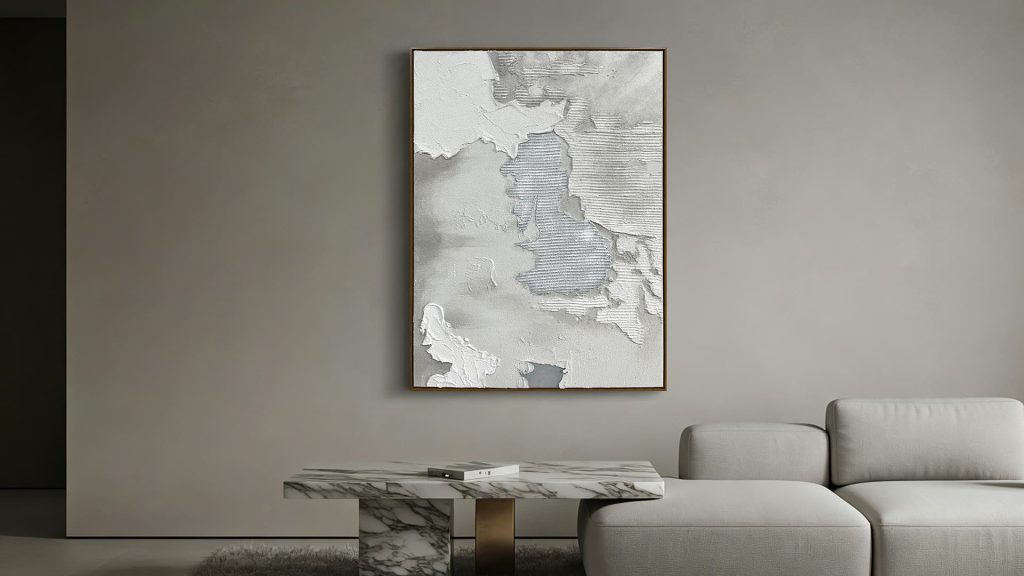 Abstract sandstone-textured wall art in the neutral modern living room.